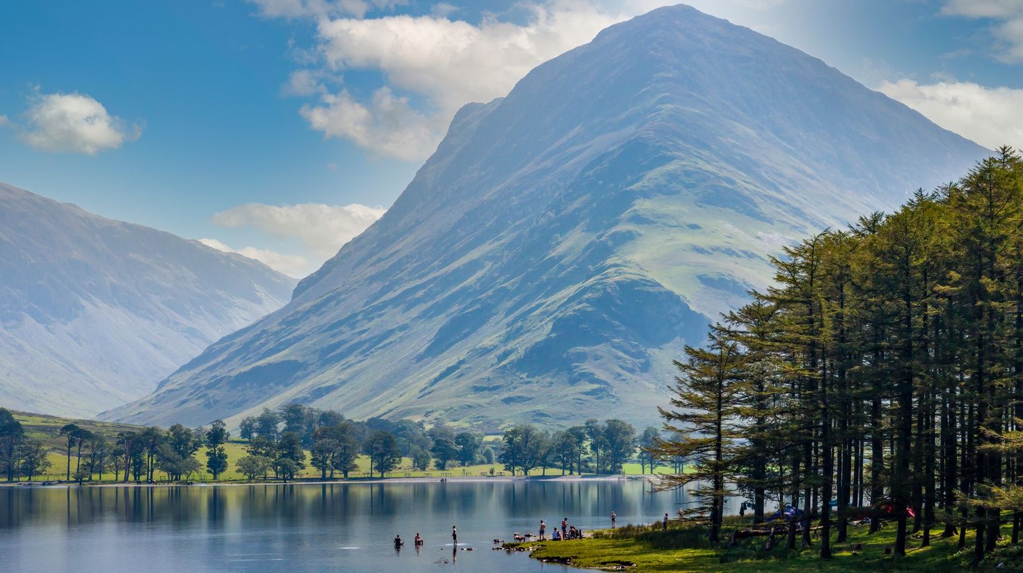 A serene lake of Buttermere surrounded by green hill in Lake District