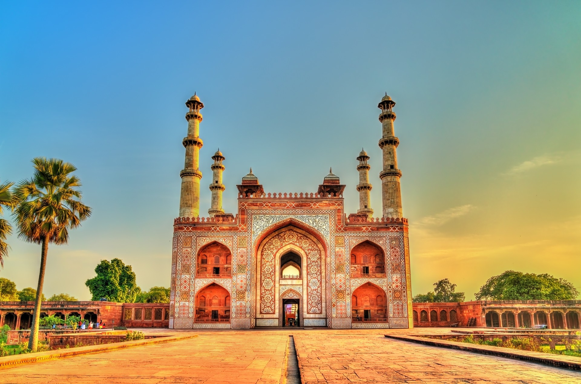 The ornate gates of Sikandra Fort, the tomb of Akbar, are said to be more beautiful than the tomb itself A red structure in India with white patterns on the walls