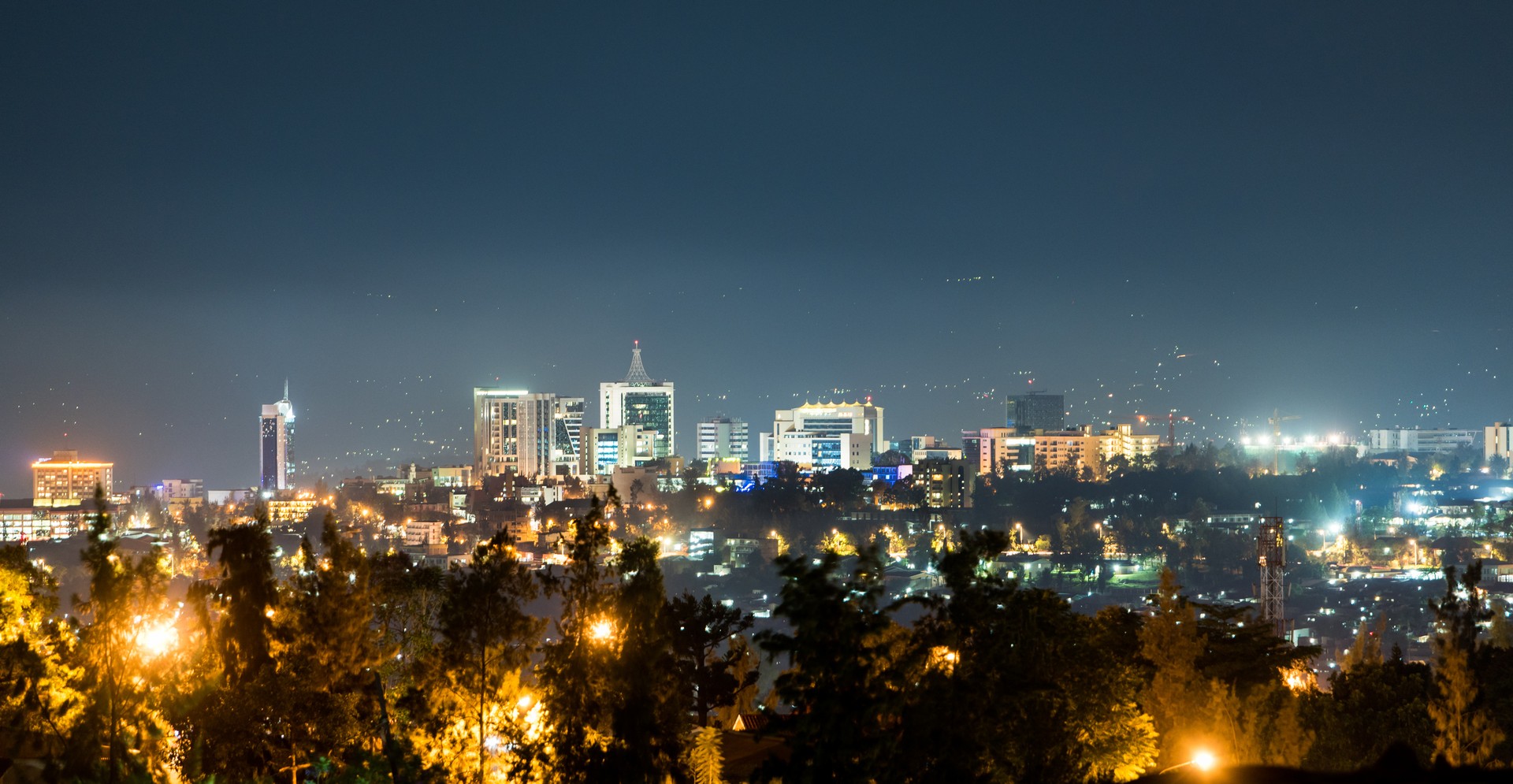 Experience the amazing night skyline and the glow of streetlights in the Kigali foreground Kigali city skyline during the quiet hours of the night
