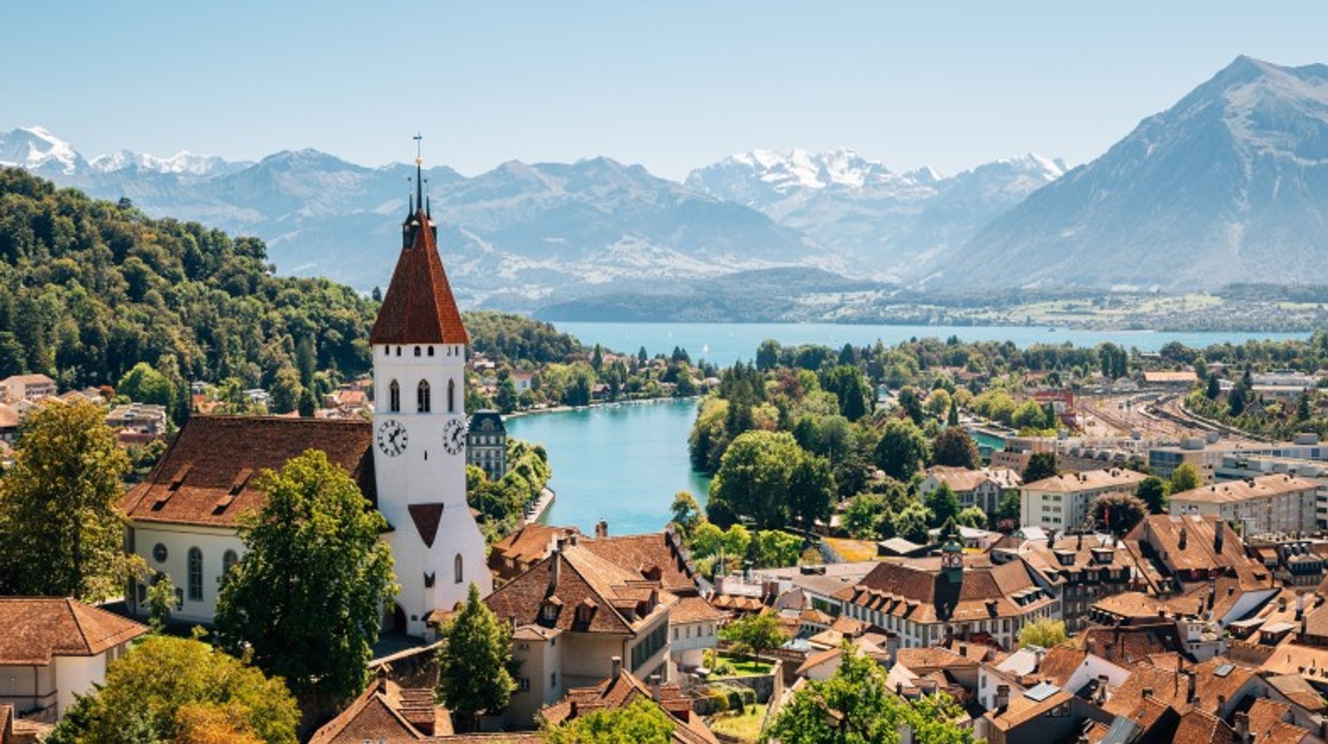 Switzerland is a landlocked country featuring gigantic mountains, deep lakes, green valleys, and thriving cities that blend the old and the new Thun city space with Alps mountain and lake in Switzerland