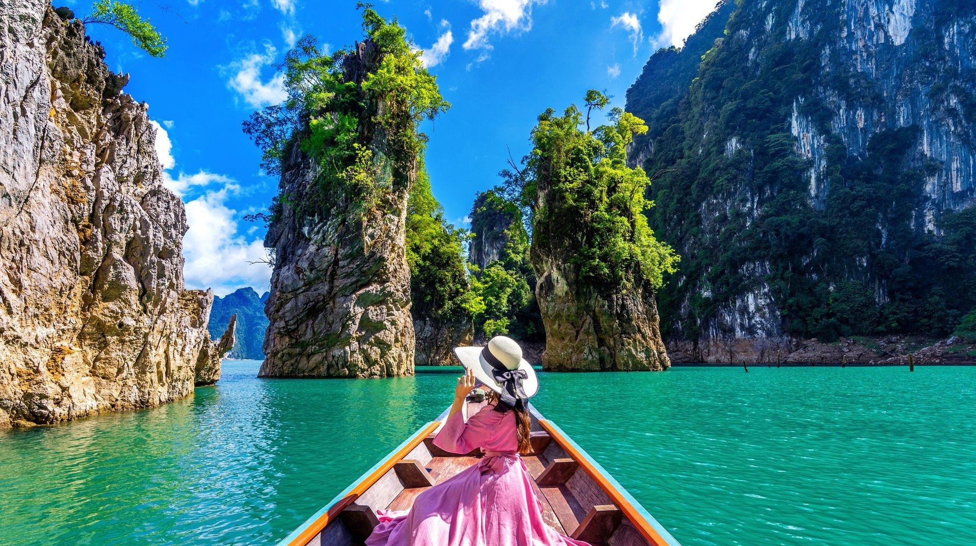 A girl in the boat in Khao National Park on a clear day; how many days to spend in Thailand.