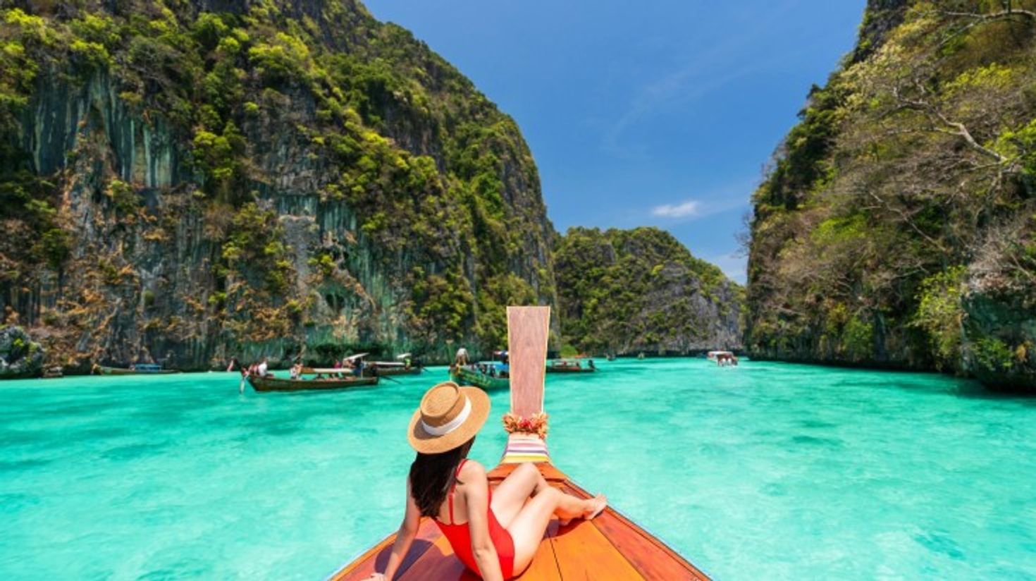 A woman relaxing on the boat in Phi Phi Island on a clear day in Thailand.