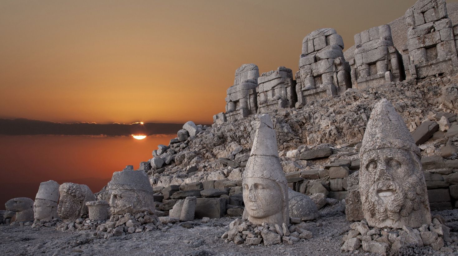 Ruins and fascinating statues at Mount Nemrut during sunset.