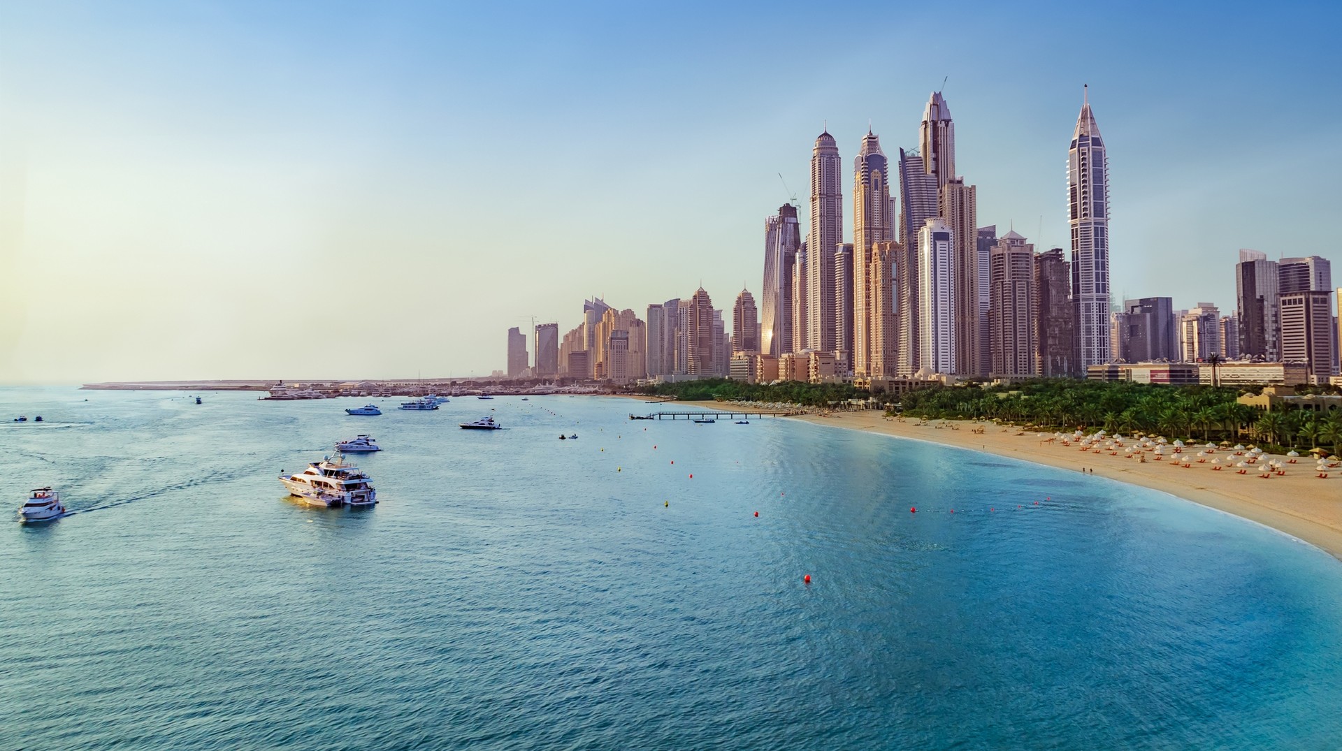 Dubai Marina, an artificial canal city district in Dubai is a popular destination in the United Arab Emirates Beach and skyline view of Dubai Marina, UAE