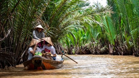 People canoeing through Mekong River Delta.