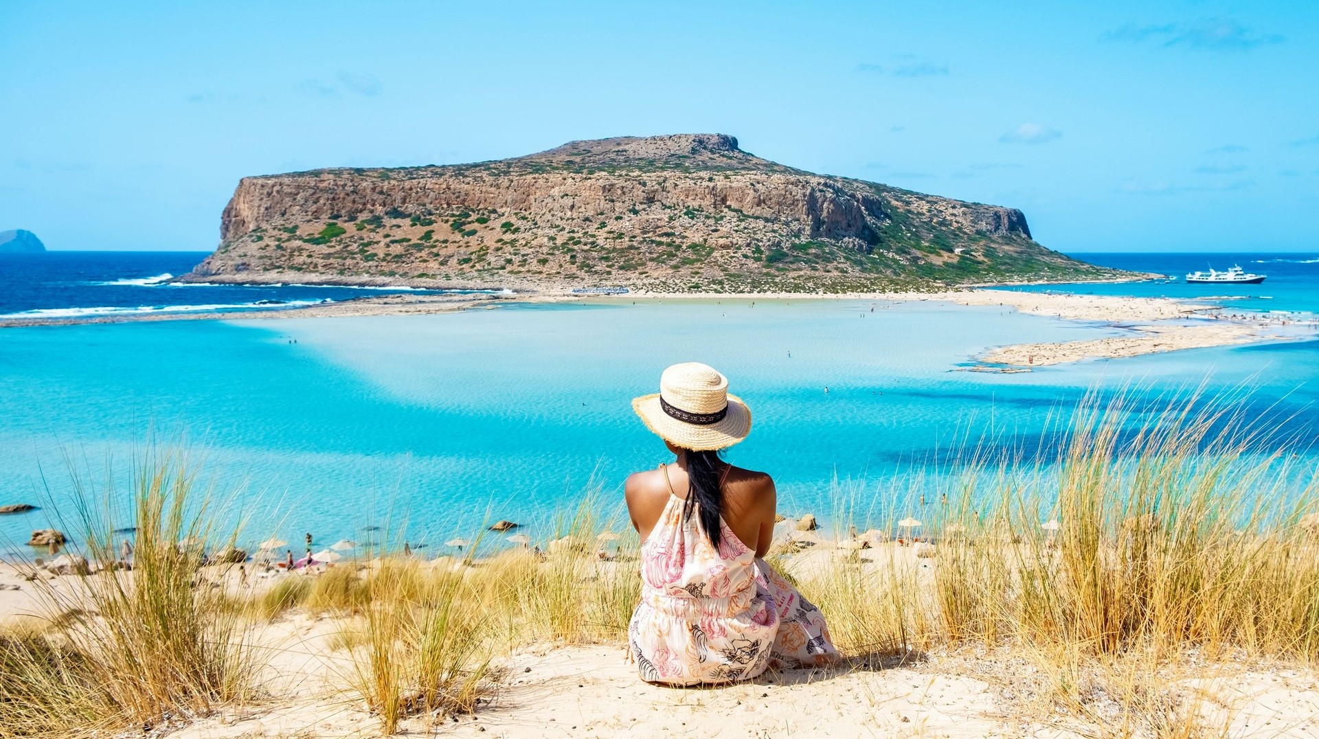 Relax at Blue Lagoon and immerse yourself in its serene turquoise waters and stunning natural beauty during your 4 days in Greece. A girl admiring Balos Lagoon in Crete during her 4 days in Greece.