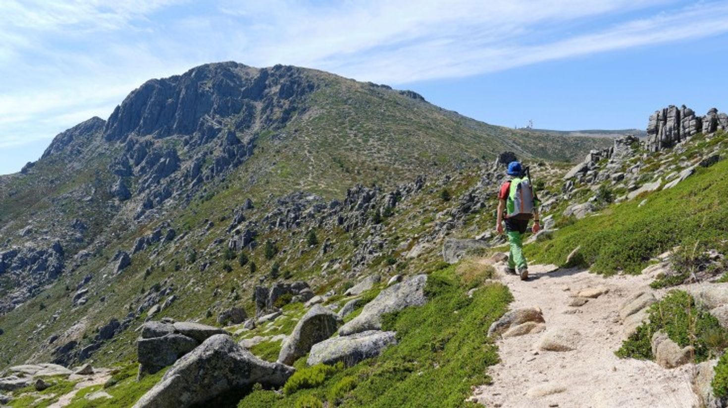 A man hiking in Messaria on a clear day in Greece.