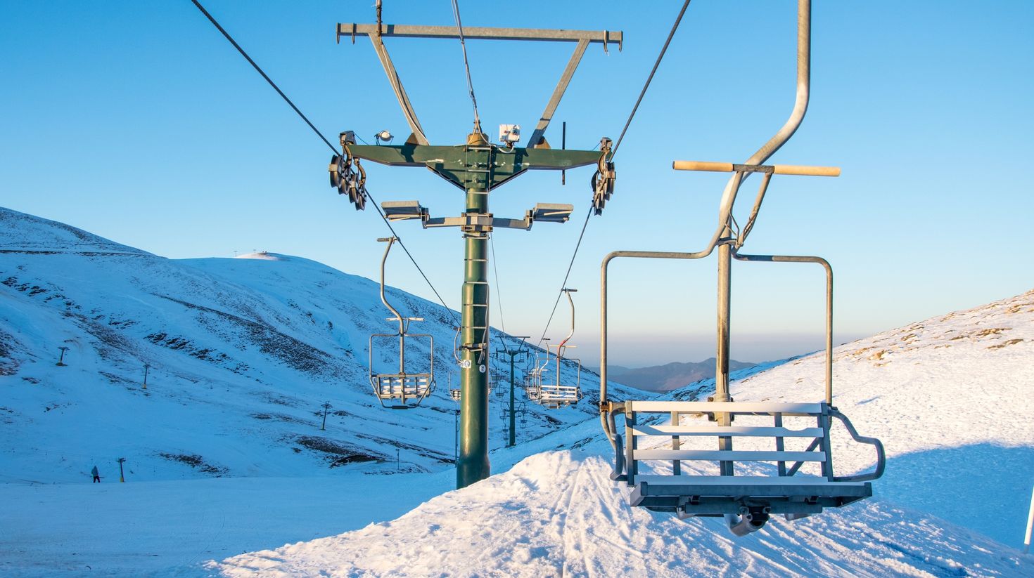Empty chairlifts in a ski resort on a sunny day