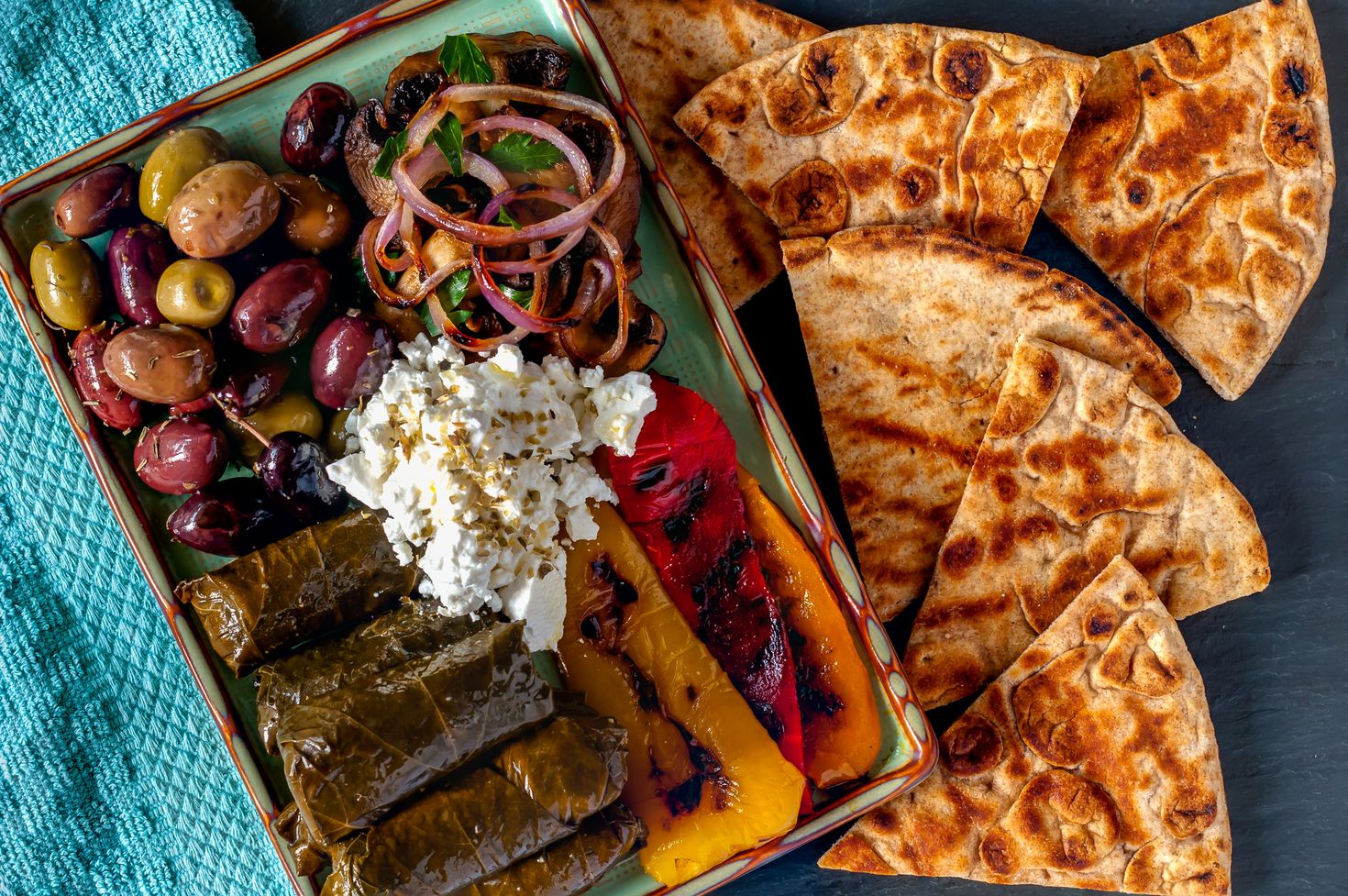 Dolmas, Greek olives, feta cheese, grilled peppers, grilled mushrooms.