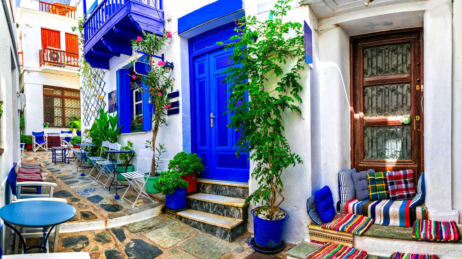 Traditional narrow streets with cute cafe bars in Greece