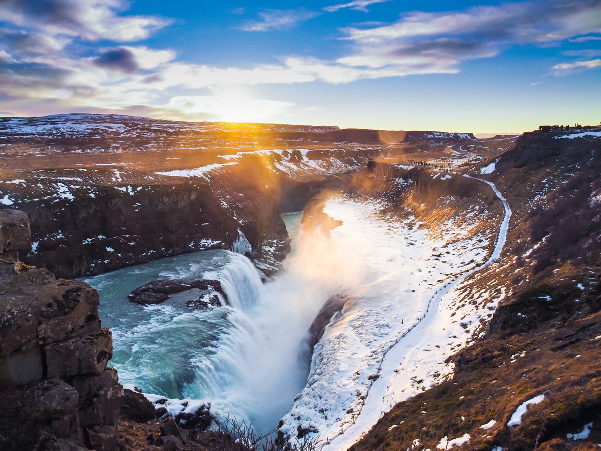 The extremely beautiful Gullfoss waterfalls tumble down from its rugged surroundings to a cloud of mist that gives off a golden sheen against the sunlight Gullfoss waterfall in Iceland is an iconic waterfall known by many