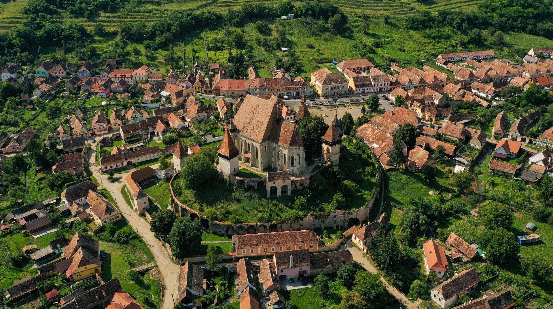 Biertan fortified church is one of the most stunning Transylvanian Saxon structures. Aerial view of a church surrounded by a village in Transylvania