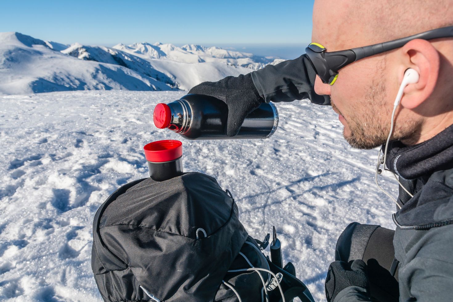 A tourist pouring hot water in the middle of the hike to Antarctica.