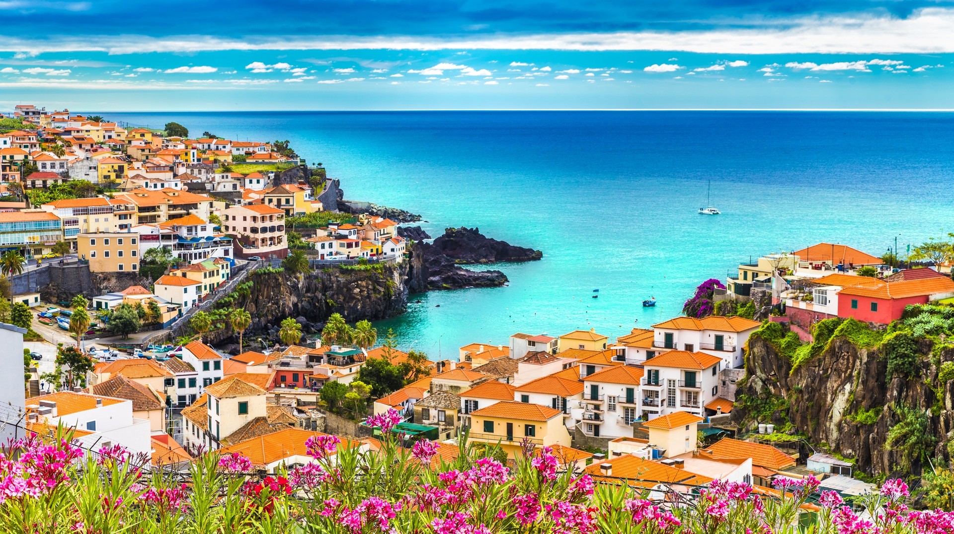 Câmara de Lobos in Madeira Island is a fishing town and one of the most photographed locations on the island. The white-washed coastal towns of Madeira sit next to blue vast sea, but getting to Madeira is no longer possible via waterways.