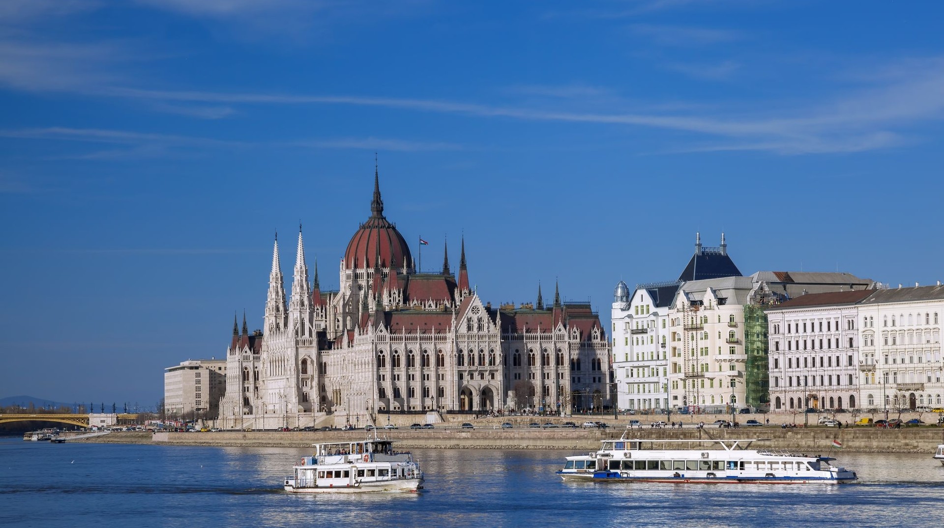 Sail along the enchanting Danube River during your week in Hungary, where breathtaking landscapes and historic cities unfold around every bend. Cruise in the Danube river in front of Parliament on your one week in Hungary.