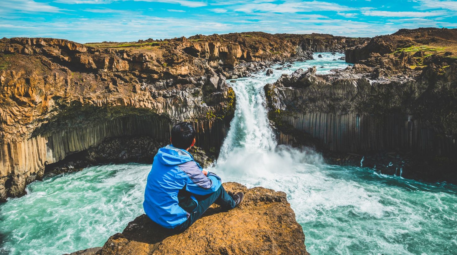 Traveler hiking in Icelandic summer landscape