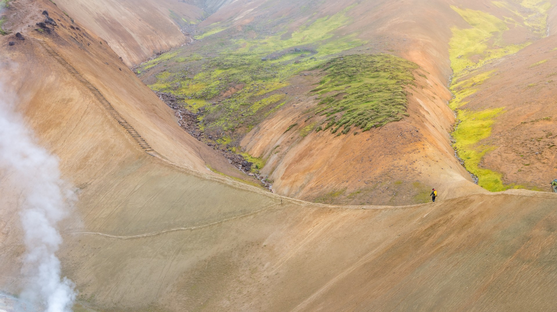 Hot Steam rises from the geothermal pools at the bottom of the mountains in Iceland in August.