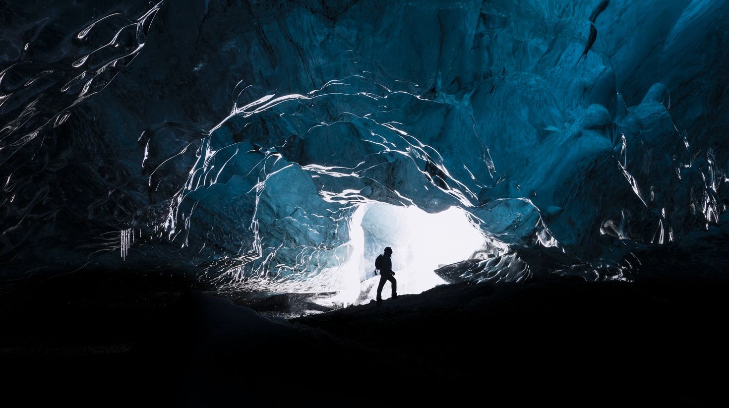 Man exploring an amazing glacial cave in Iceland