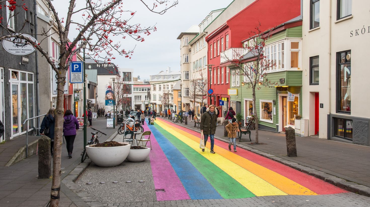 People walking on the rainbow painted Skolavordustigur Iceland