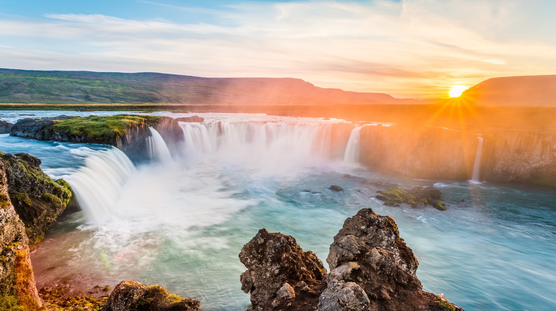 Witness the majestic beauty of Godafoss waterfall, driving the Golden Circle during your two weeks in Iceland. Two weeks in Iceland: Witness sunrise at Godafoss waterfall, Golden Circle.