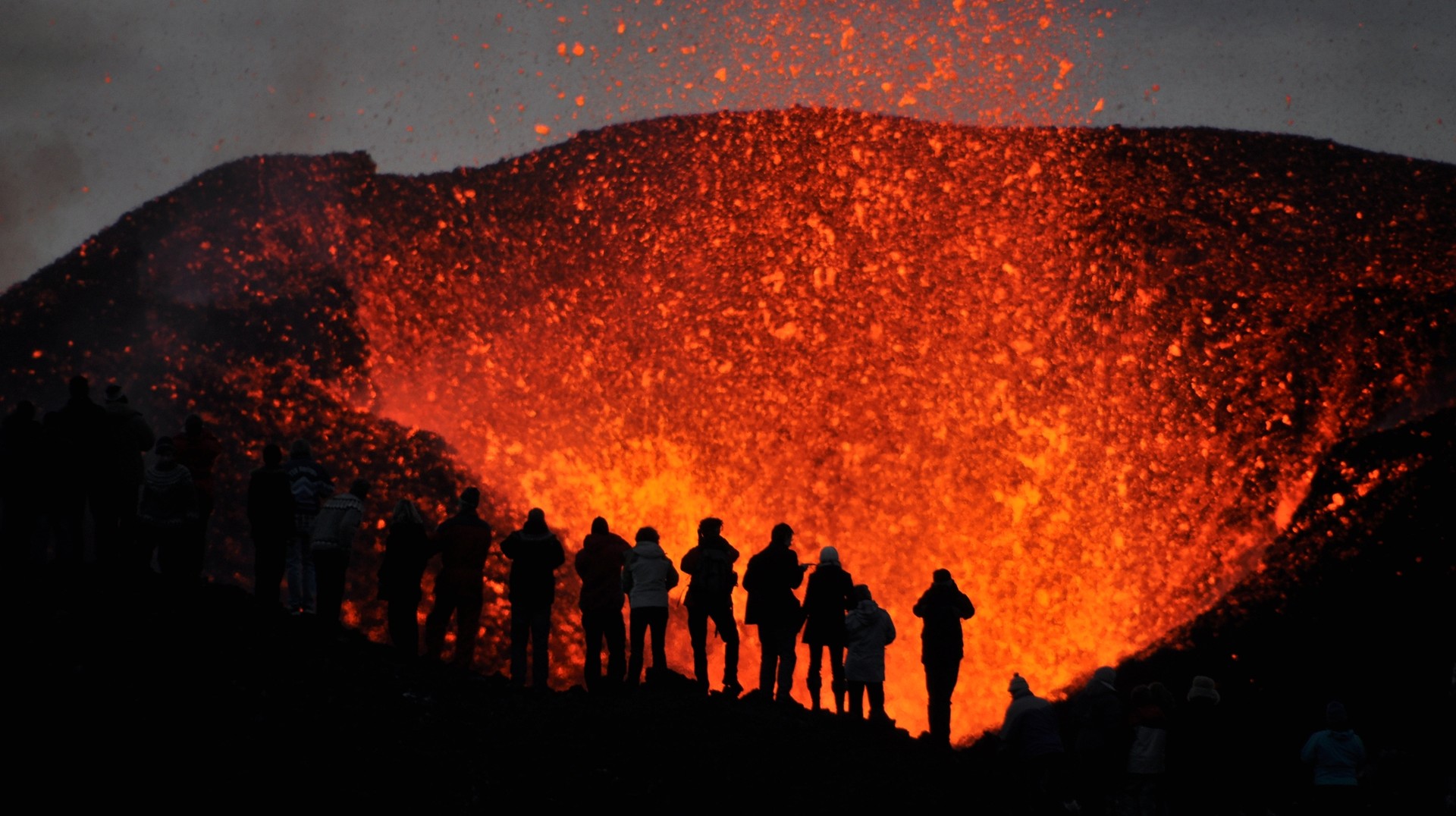 Volcanoes in Iceland are one of biggest attraction that draws many thrill-seeking individuals to the country. A group of visitors witnesses a volcano eruption