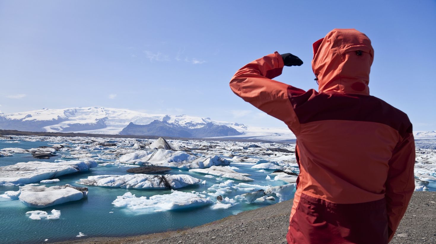 Man admiring the beauty of Jokulsarlon Glacier Lagoon up close.