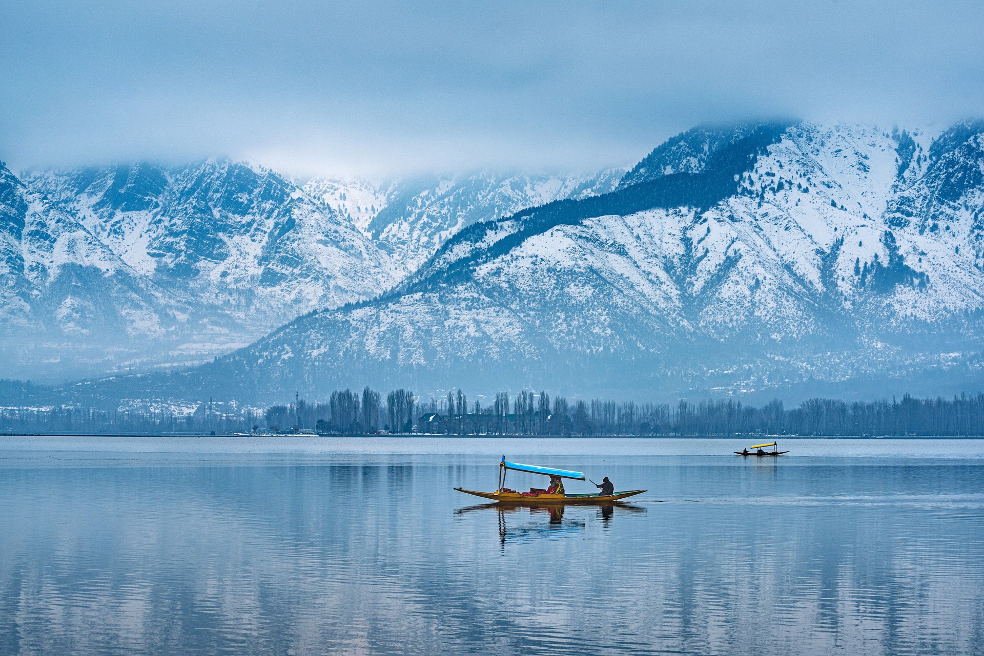 Experience the chilling beauty of Kashmir on your trip to India in January View of Dal Lake in winter, and the beautiful mountain range, Kashmir