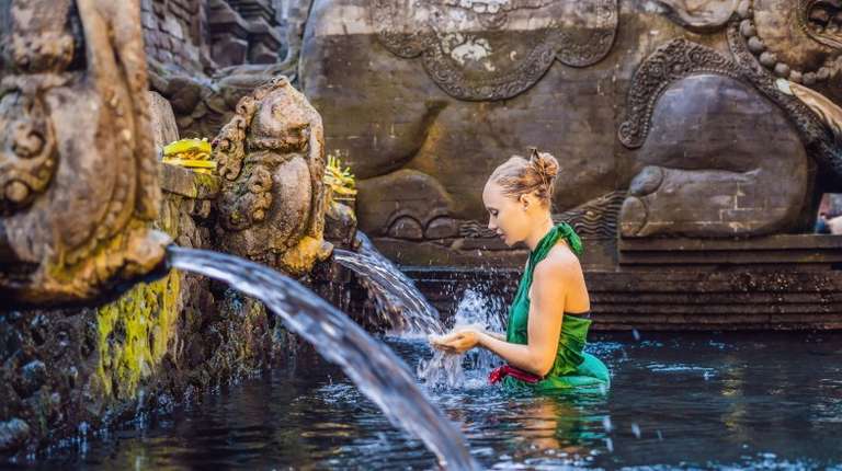 Women in the holy spring water temple in Indonesia in December.