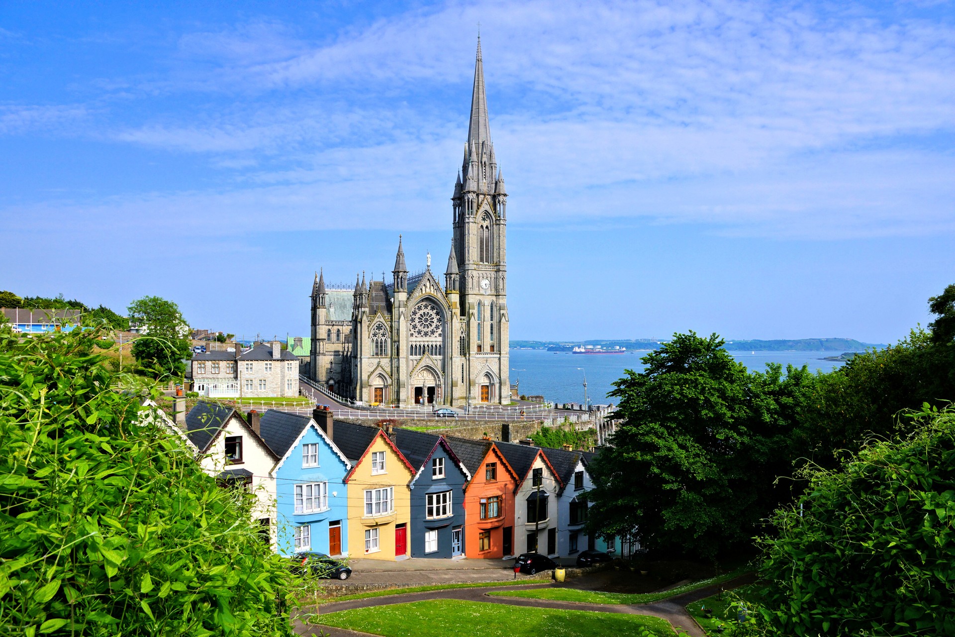 Experience the lore of County Cork on your trip to Ireland in February Colorful row houses with the towering cathedral in background, Cork, Ireland