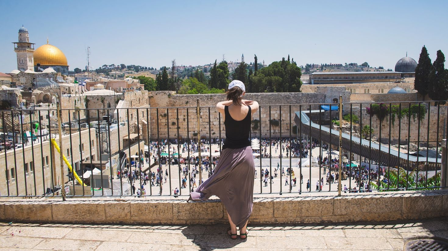 A woman tourist enjoying the view of Jerusalem from the top,