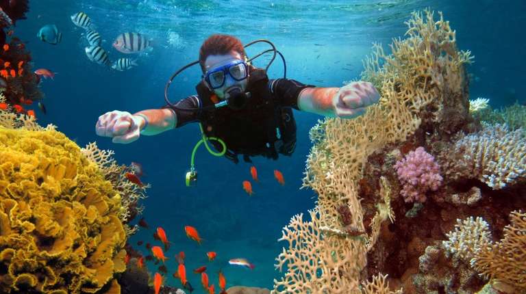 A happy man scuba diving in Israel in February.