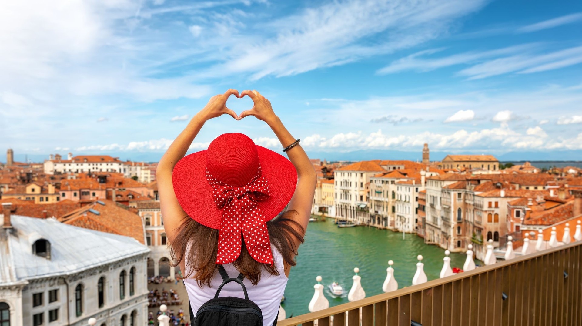 A female tourist posing over the skyline in Venice during her 4 days in Italy trip.