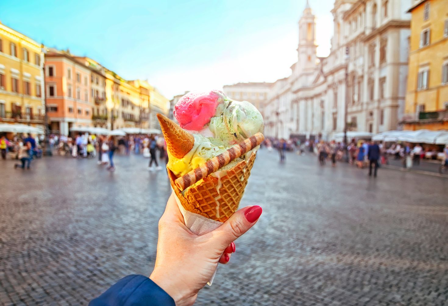A woman holding a gelato in the streets of Rome in Italy