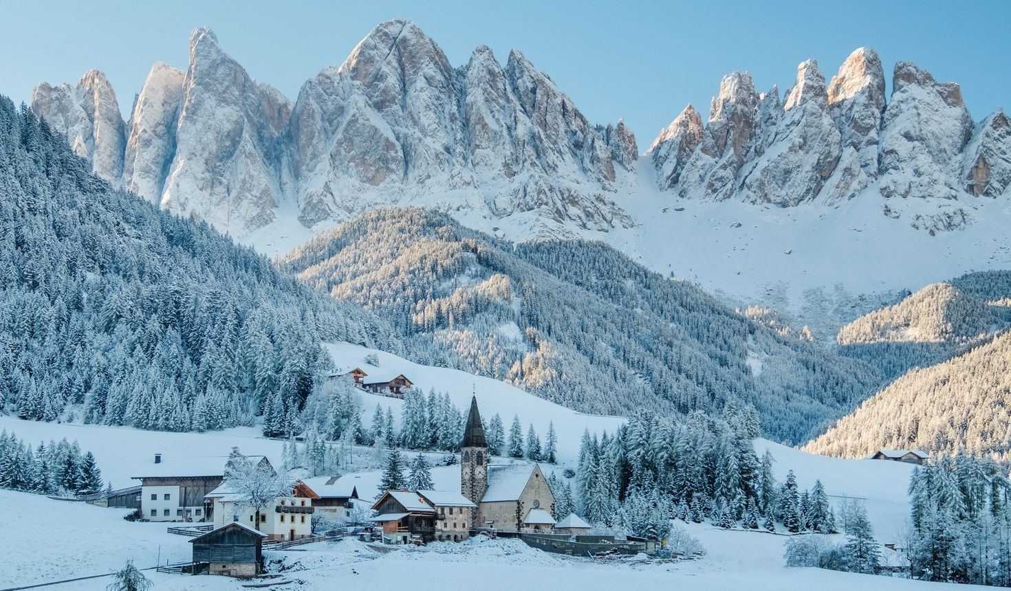 A small village in Dolomites covered with snow top roofs