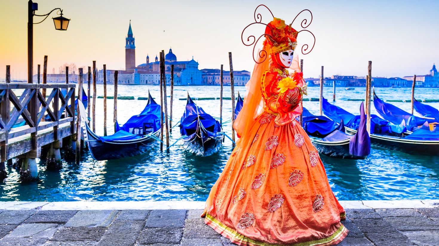 A lady in a beautiful attire and mask for the Venice Carnival in Italy.