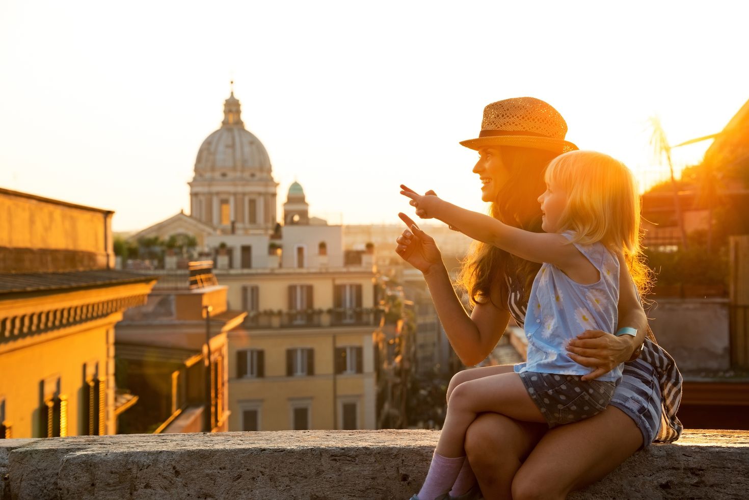 Mother and her baby girl sitting and enjoying the scenic beauty of Rome
