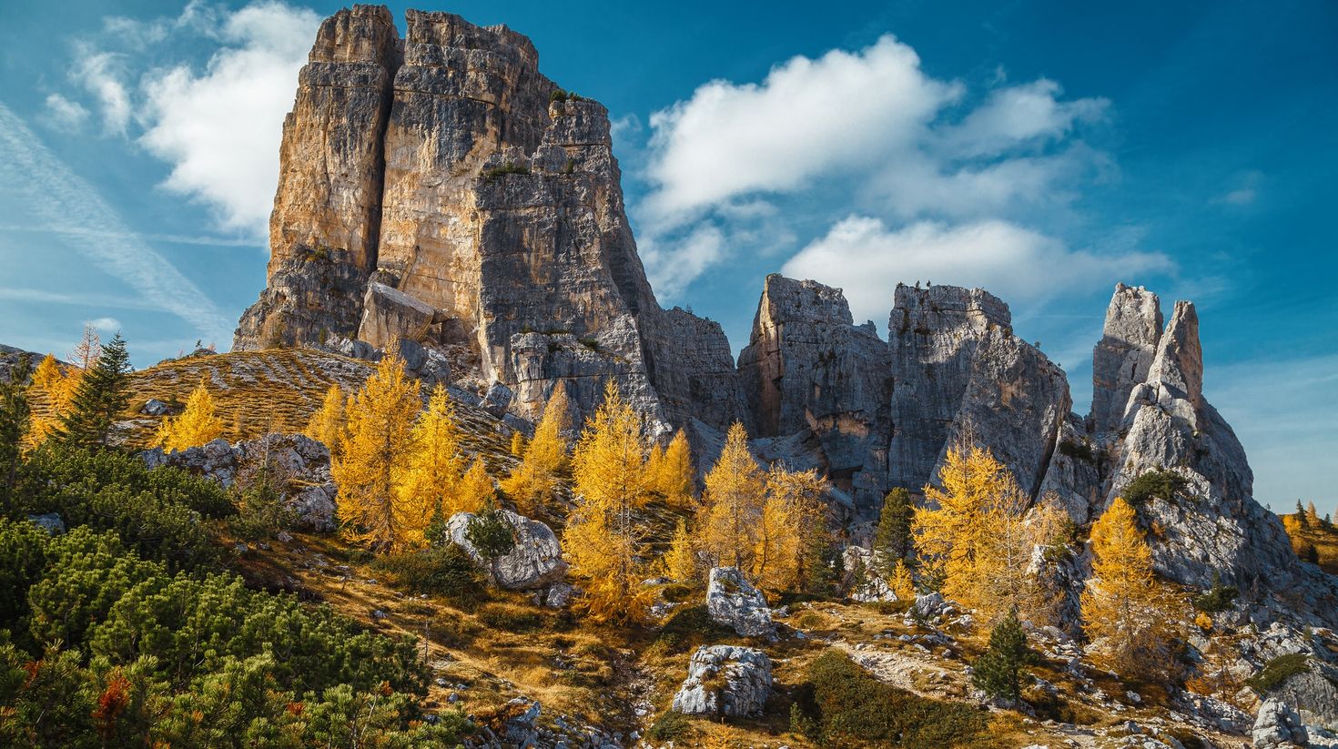 Alpine autumn landscape with colorful larches in Cinque Torri cliffs