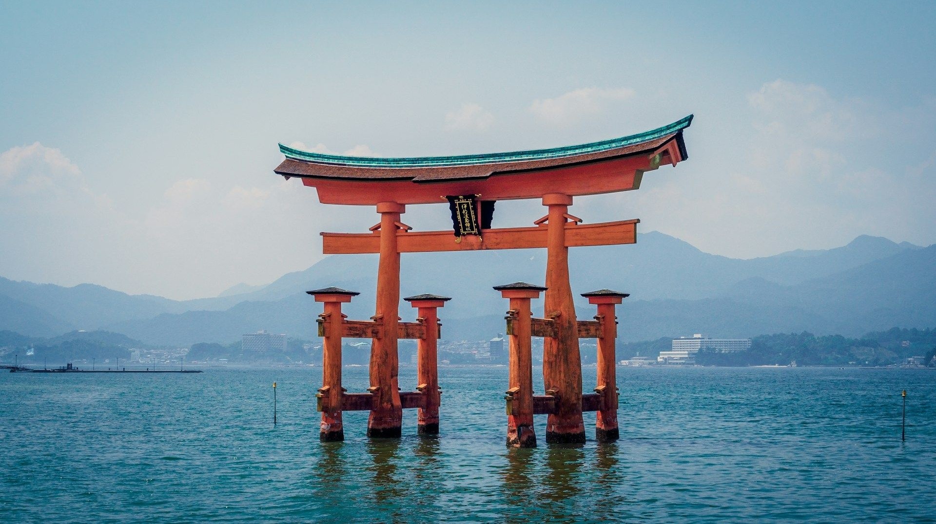 The red torii gate of Itsukushima Shrine seems to be floating on water during high tide. The famous floating torii gate of Itsukushima Shrine in Japan