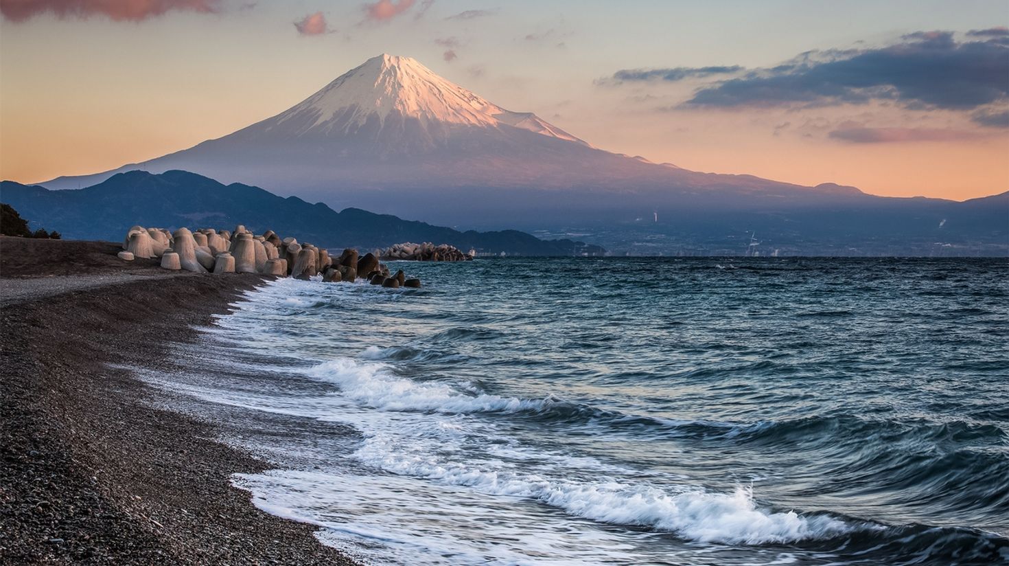 Mount Fuji and a sea beach during sunset.