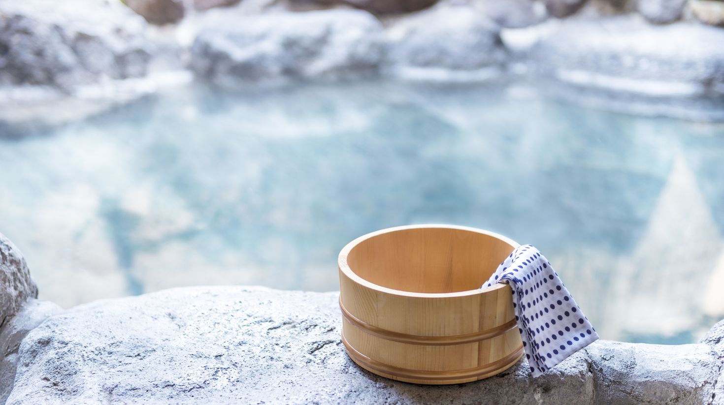 A Japanese hot spring with bucket and bath towel.
