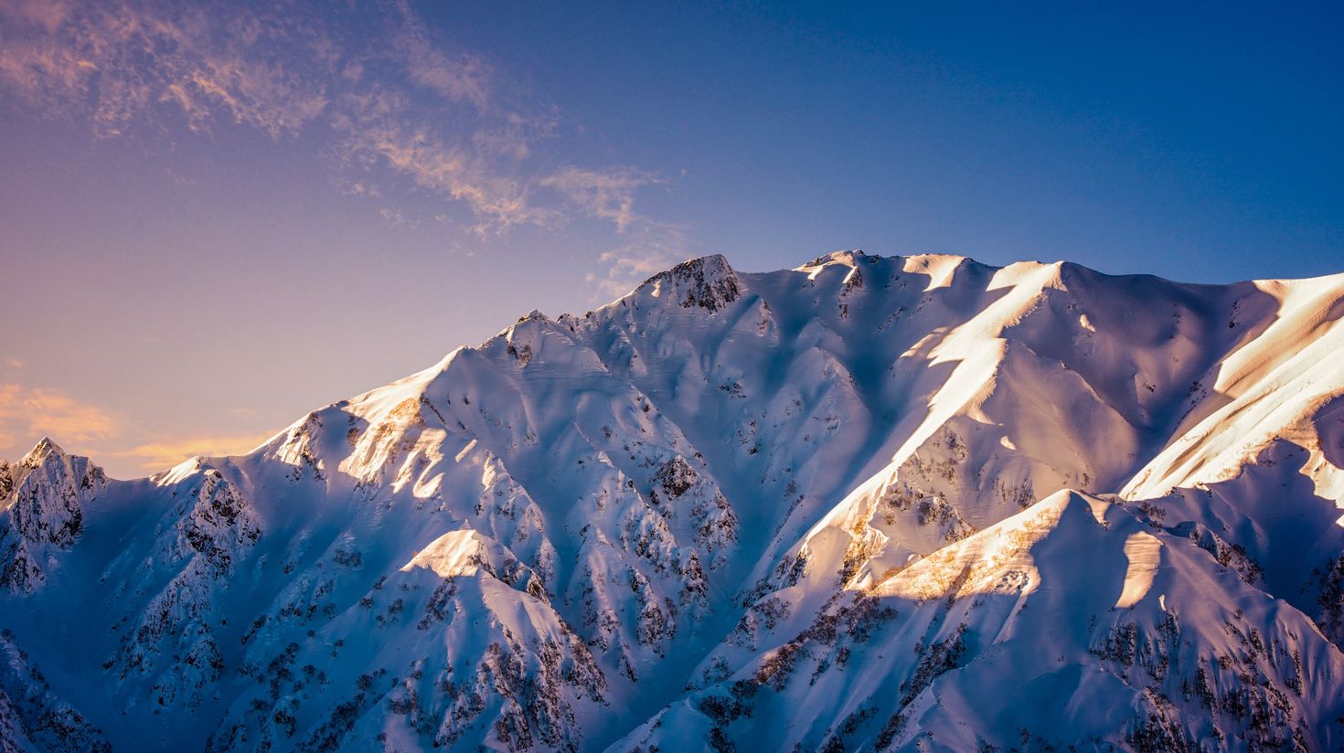 Extreme pro-skier shredding the deep snow in the sunny Japanese weather.