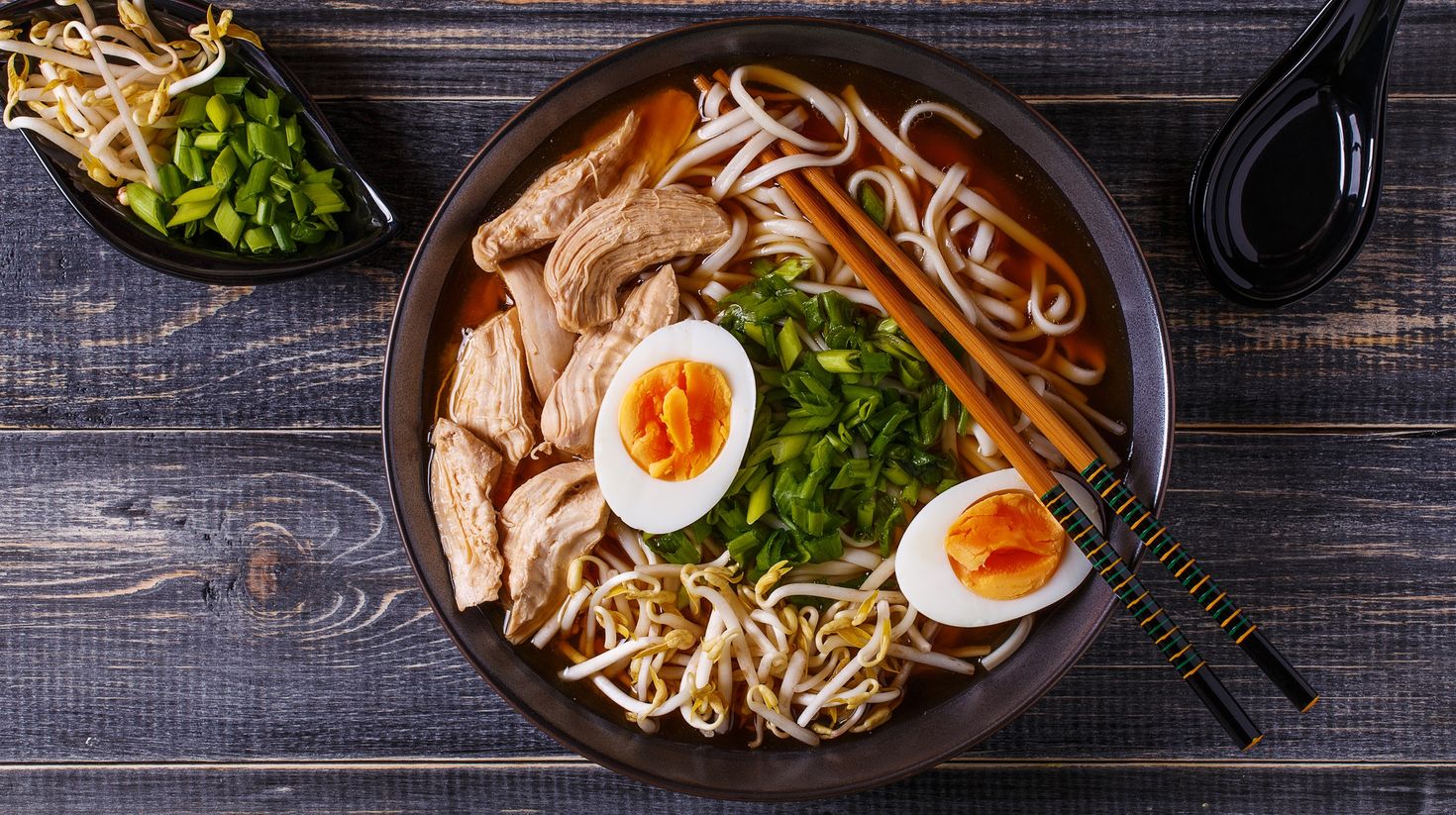 Japanese ramen soup with chicken, egg, chives and sprout.