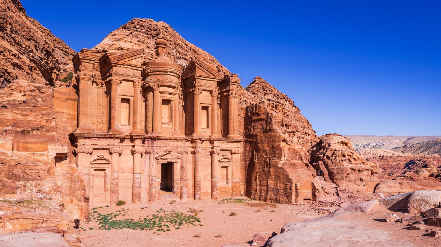 The stunnung view of Ad Deir, the Monastery of Petra on a blue sky spring.