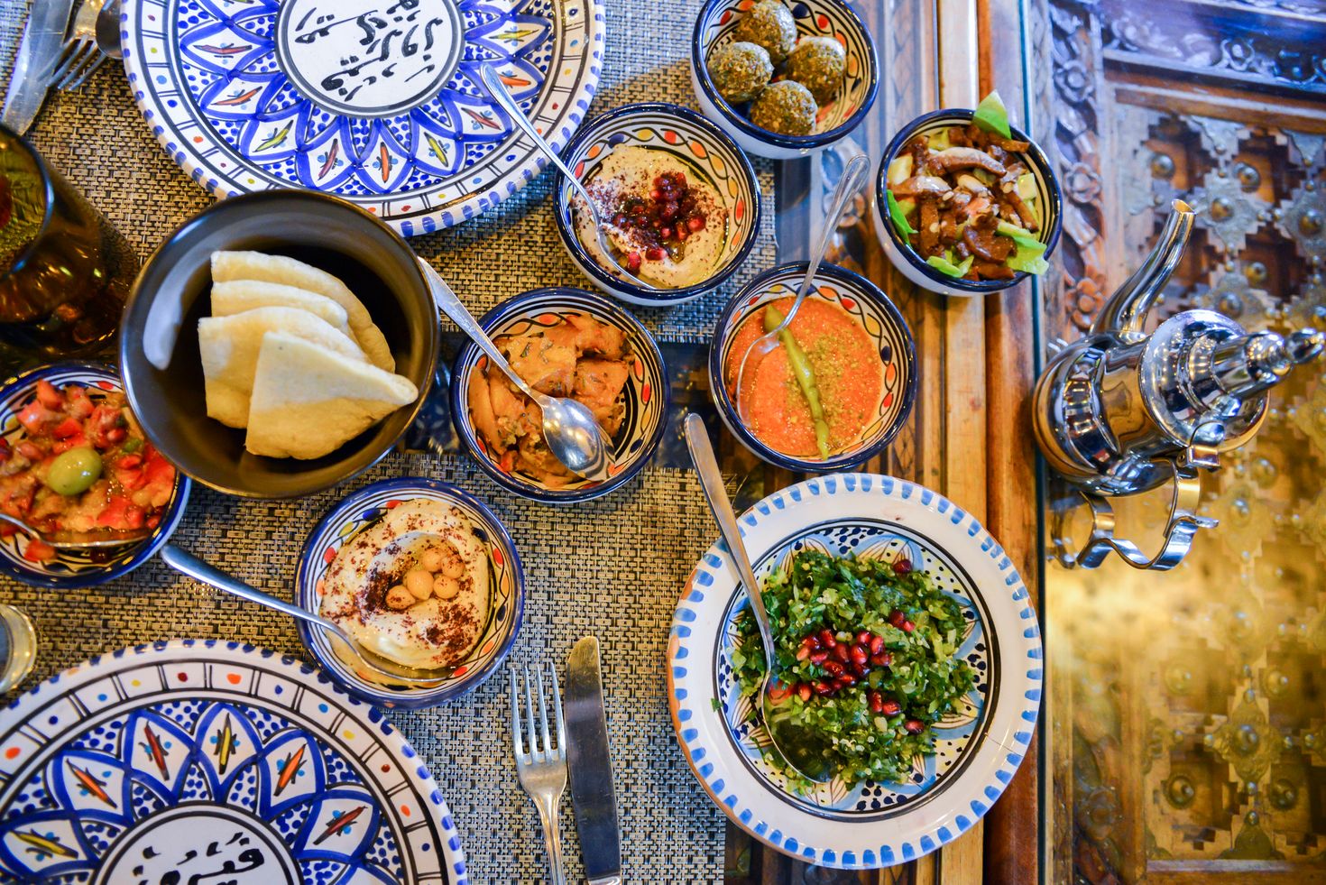 Jordan dishes and assorted breads, meats, rice in the table.