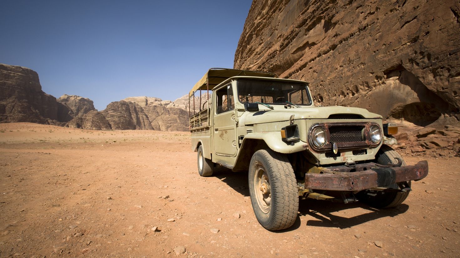 An old run down 4*4 vehicle in the desert of Wadi Rum.