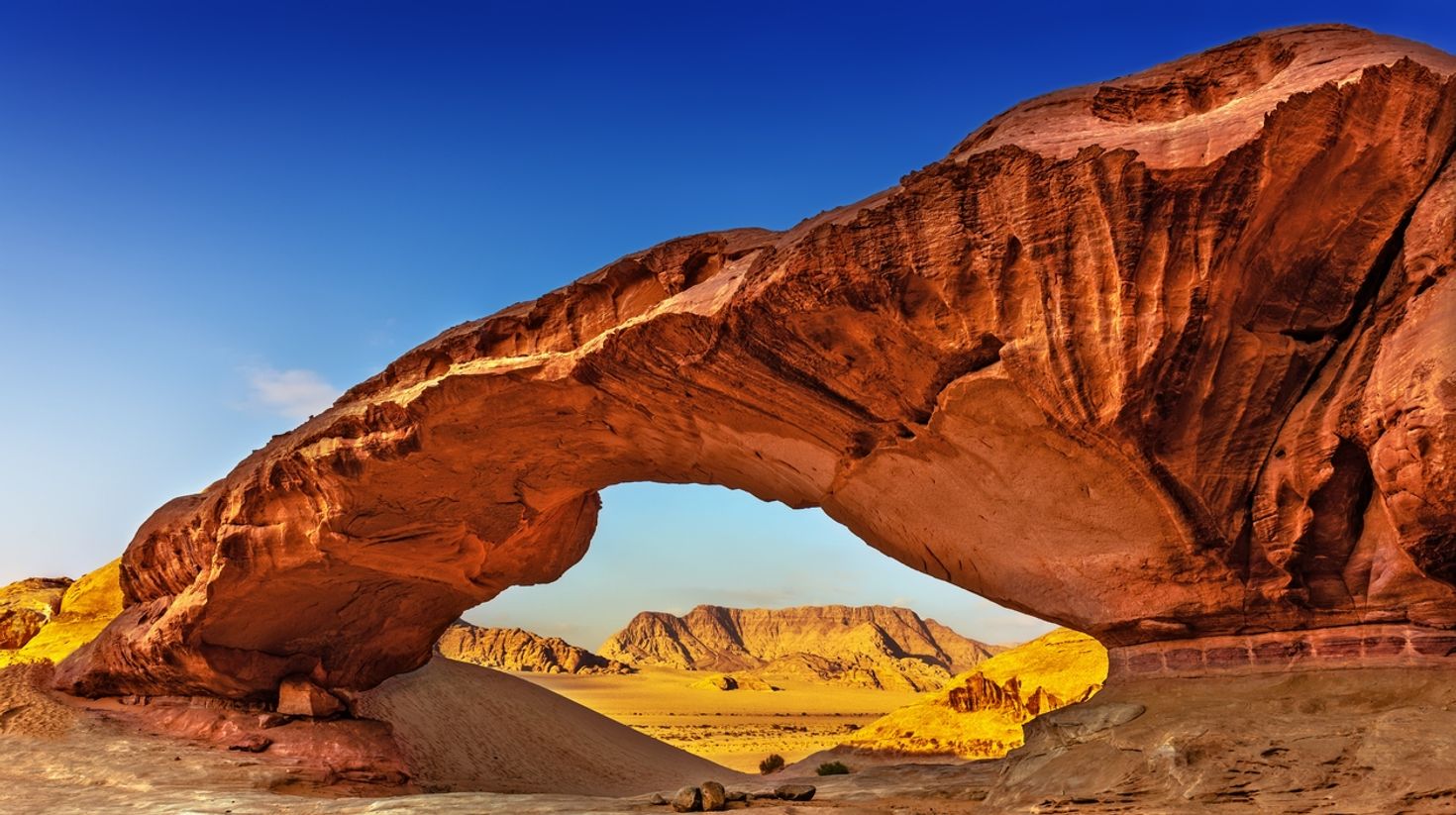 Rock Arch in Wadi Rum in clear sky in August