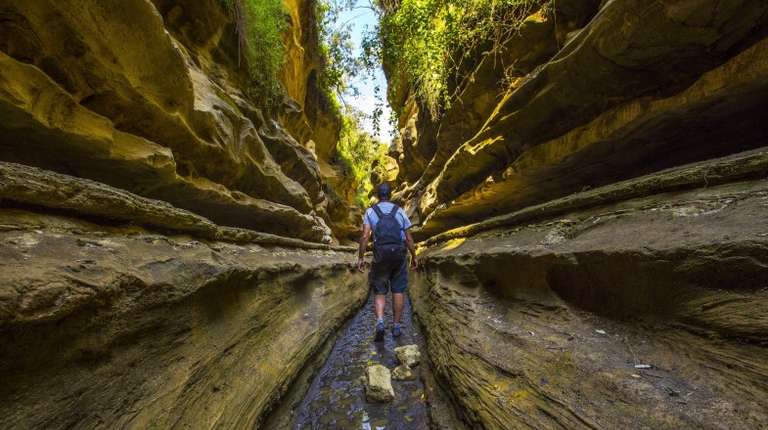 Man exploring Hell's Gate National Park during 8-day itinerary in Kenya