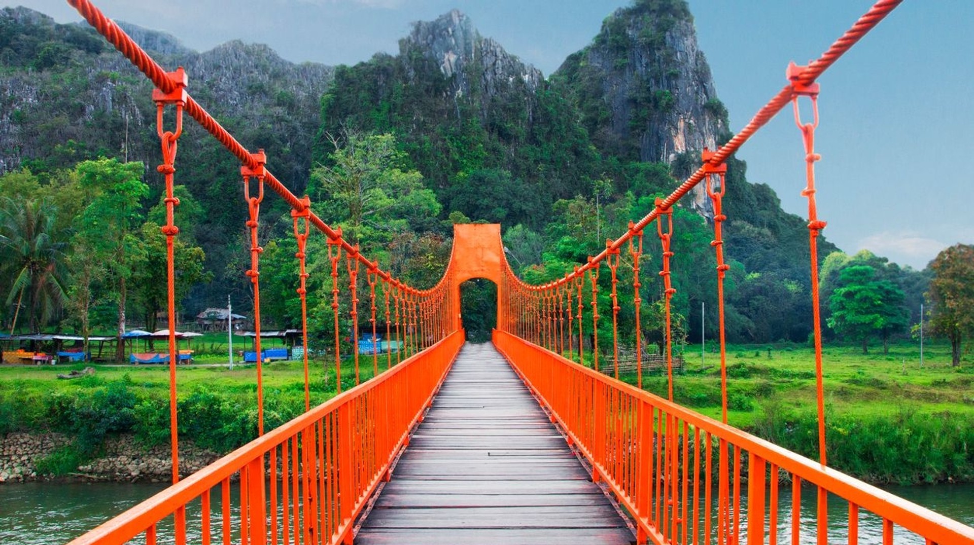 Cross the iconic orange bridge in Vang Vieng during your 5 days in Laos.
