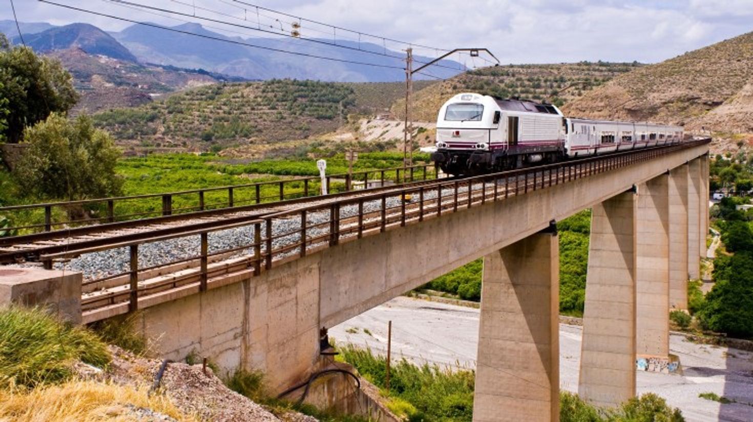 A train traveling from Madrid to Cordoba on a clear day.