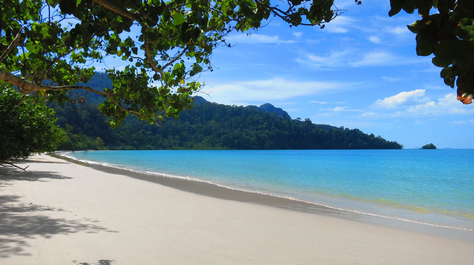Relax on the tropical beaches in Langkawi on your holiday in Malaysia in October. Empty beach with crystal clear water in Langkawi in Malaysia in October.